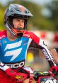 Jett speaks with confidence while preparing for motocross, showcasing his Geico gear and vibrant racing spirit.