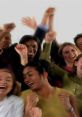 Diverse group of people cheering and applauding, expressing joy and celebration with raised fists and radiant smiles.