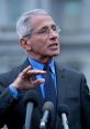 Dr. Fauci speaks passionately at a press conference, addressing key public health issues with microphones in front of him.