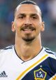 Zlatan Ibrahimovic smiling in LA Galaxy jersey, showcasing his charismatic personality and soccer greatness.