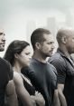 Fast and Furious crew standing side by side, showcasing teamwork and strength in a dramatic urban backdrop.