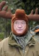 Man wearing a humorous moose hat in a forest, showcasing a quirky side of Swedish outdoor apparel.