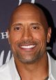 Dwayne Johnson smiles, showcasing his charismatic personality and signature style at a public appearance event.