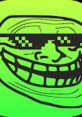 Green troll face with oversized grin and sunglasses, representing internet meme culture and humorous trolling behavior.