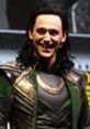 Loki character in dark green and gold attire, showcasing his iconic mischievous smile at a promotional event.