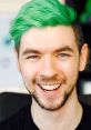 Jacksepticeye smiling with vibrant green hair, showcasing his energetic personality and engaging content style.