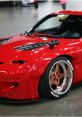 Stylish red JDM sports car with custom wheels and modified body kit, showcasing automotive passion and culture.