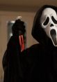 Scream character holds a bloody knife, embodying horror and suspense in a dark, eerie setting.