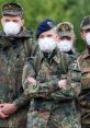 German soldiers in camouflage uniforms wearing face masks, showcasing military readiness and health precautions.