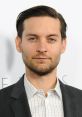 Tobey Maguire displays a sharp look in a suit, highlighting his stylish persona and Hollywood presence at a premiere event.