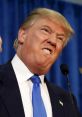 Donald Trump expressing strong emotions at a press conference, wearing a suit and blue tie, with an intense facial expression.