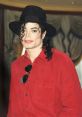 Michael Jackson wearing a red shirt and black hat, showcasing his iconic style and charismatic presence.