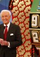 Bob Barker smiles as he hosts the iconic game show "The Price Is Right," with the game wheel in the background.