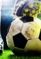 Close-up of a football with a player's boot on it, showcasing the textured surface and vibrant green grass. Perfect for soccer lovers.