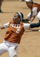 Texas softball player in action, pitching with concentration during a competitive game on the field.