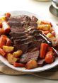 Savory roast beef sliced and served with carrots, potatoes, and herbs on a white platter, perfect for family dinners.