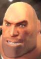 Close-up of the Heavy from TF2, showcasing his intense expression and distinctive bald head, embodying strength and power.