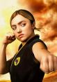 Tory Nichols from Cobra Kai strikes a powerful pose, showcasing her strength and determination in martial arts.