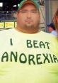 Man wearing a yellow shirt with "I BEAT ANOREXIA" text, showcasing body positivity and humor related to weight struggles.