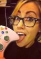 Funny meme featuring a gamer girl playfully licking an Xbox controller, celebrating gamer culture and humor.