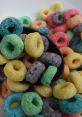 Colorful, crunchy loops in a black bowl, perfect for breakfast or snacking—vibrant flavors and fun shapes await!