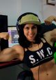 Empowered gamer girl flexing muscles in a stylish outfit, showcasing strength and confidence in a gaming setup.