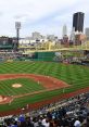 Vibrant scene at PNC Park during a baseball game, showcasing players, fans, and the iconic Pittsburgh skyline.