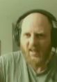 Man with headphones showing intense expression, capturing the essence of Tense1983 - 2022 gaming or streaming culture.