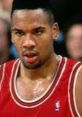 Stacey King in a red NBA jersey during an intense basketball game, showcasing determination and focus on the court.