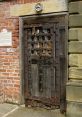 Historical prison door with intricate metalwork, showcasing rustic wood and iron details from an ancient penal facility.