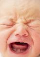 Crying baby with a distressed expression, showcasing emotion and vulnerability in a close-up shot.