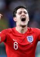 Harry Maguire celebrating passionately during the 2018 World Cup match, wearing England's iconic red jersey.