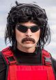 Dr Disrespect sporting iconic sunglasses and a signature mullet hairstyle, dressed in a red tactical vest for a bold look.