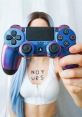 PS4 gamer girl showcasing a colorful controller with "NOT UARS" tattooed on her chest, embodying gaming culture and style.