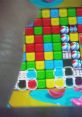 Hand moving over colorful blocks in Toy Blast; showcasing effects in a vibrant mobile gaming environment.