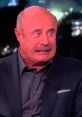 Dr. Phil looking shocked and concerned, reacting humorously to a prank call on a late-night show.