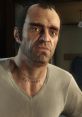 Trevor Philips from GTA V showing intense expression and distinctive "CUT HERE" tattoo on his neck.