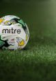 Mitre football resting on vibrant green grass, showcasing its design for the Football League. Perfect for game day.