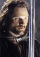 Aragorn, the noble ranger, gazes intently while holding the legendary sword Andúril in a dramatic scene from LOTR.