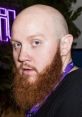 TimTheTatman with a thick red beard, bald head, and intense gaze, exuding a charismatic gaming presence.