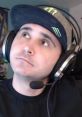 Streamer Summit1g wearing a cap and headset, looking thoughtfully while engaging with his audience in a gaming session.