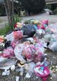 Piles of colorful trash bags and scattered waste, highlighting the issue of random 丟 in urban areas.