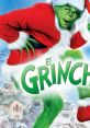 The Grinch, dressed in a Santa suit, playfully poses against a snowy Whoville backdrop in "How the Grinch Stole Christmas.