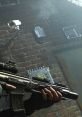 Close-up of a soldier's hand gripping a futuristic assault rifle in a gritty, urban environment from MW2.