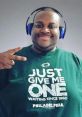 Man wearing a green shirt with "Just Give Me One" slogan, headphones on, peace sign gesture, embodying sports enthusiasm.