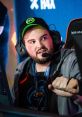 Hiko at a gaming event, wearing a headset and focused on the screen, showcasing his esports passion and dedication.