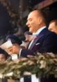 Mustafa Kemal Atatürk delivering a speech, surrounded by supporters, emphasizing his leadership and vision for Turkey.