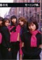 Morning Musume members in stylish outfits promoting "Memory Seishun no Hikari" with vibrant colors and an urban backdrop.