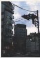 Cityscape with intersecting power lines, buildings, and traffic lights, evoking the atmosphere of "Paranoia Agent.