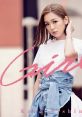 Kana Nishino posing in stylish outfit, featured in "Girls Girls" for Professor Layton ending theme. Celebrating pop culture.